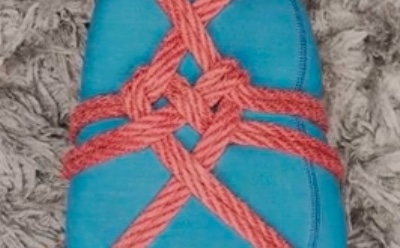 Red ropes tied around a leg with the friction in the shape of a heart